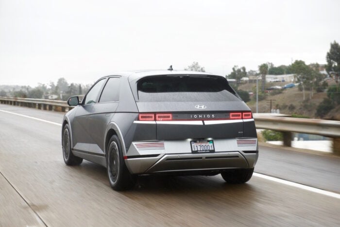 grey 2022 IONIQ 5 rear profile driving on the road