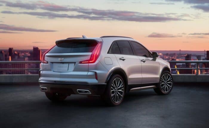 Rear 3/4 shot of the 2024 Cadillac XT4 in Argent Silver Sport featuring the updated modern rear design and all-new available 20-inch alloy wheels.