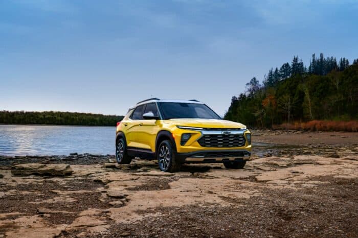 2024 Chevrolet Trailblazer ACTIV in yellow parked on rocks in front of lake