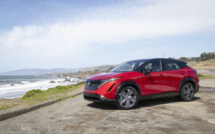 2023 Nissan Ariya e-4ORCE by the ocean in red