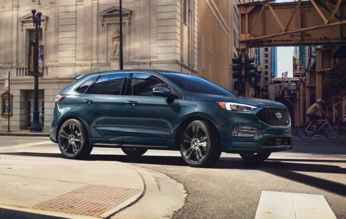 2024 Ford Edge Titanium driving on the road in the city