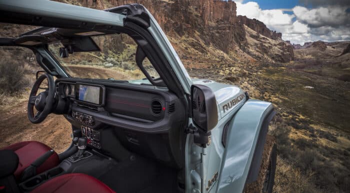 2024 Jeep Wrangler Rubicon driving through desert in Utah with interior shot