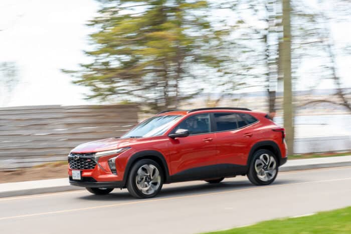 orange 2024 Chevy Trax crossover driving down the road