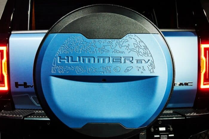 Detail shot of the 2024 GMC HUMMER EV Omega Edition SUV with the exclusive Neptune Blue Matte spare tire cover.