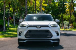 2024 Toyota Grand Highlander in white front view head on parked on the road