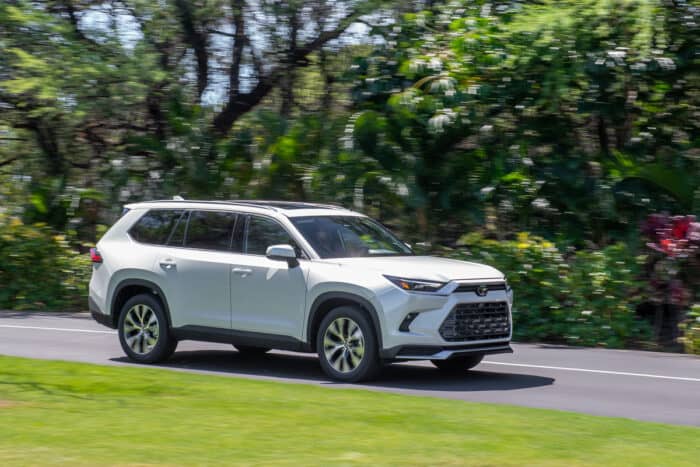 2024 Toyota Grand Highlander Limited Hybrid MAX in white front view driving