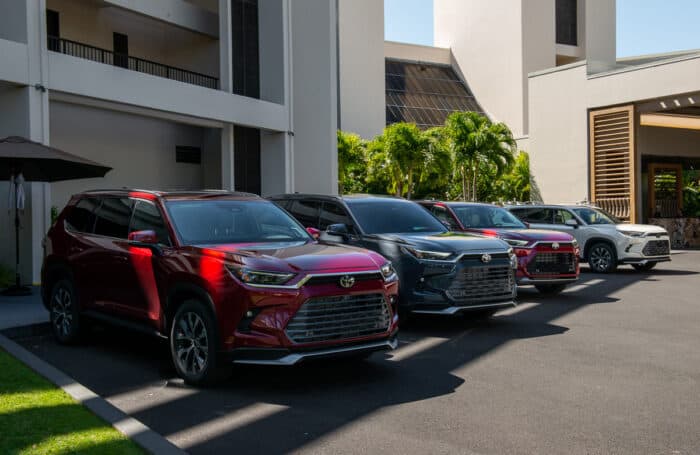 2024 Toyota Grand Highlander lineup of SUVs parked in front of hotel lobby