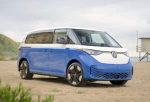 2024 VW ID. Buzz 3-Row front view in blue and white sitting on the beach