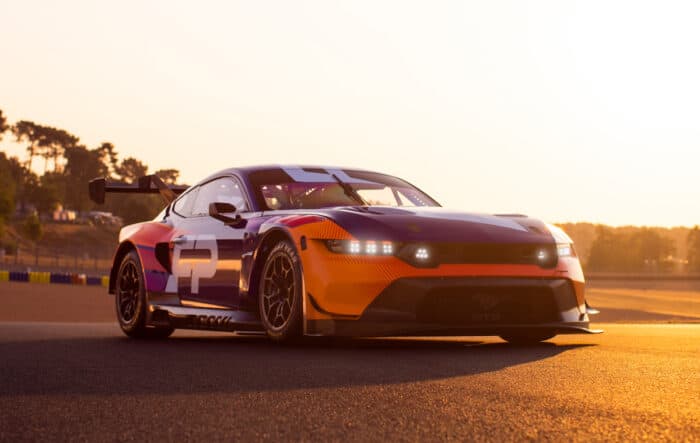 Ford Mustang GT3 race car at dusk front view on the race track at Le Mans in 2023