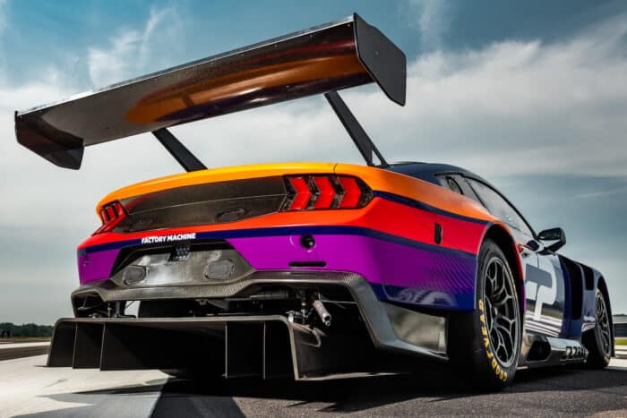 Ford Mustang GT3 race car rear view with big wing on the track