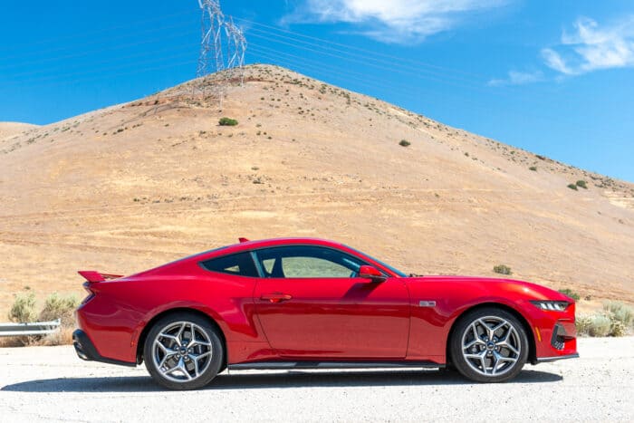 2024 Mustang GT Fastback with Performance Pack in red parked by a hill in California