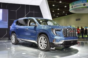 2024 GMC Acadia Denali in blue on stage at 2023 Detroit Auto Show