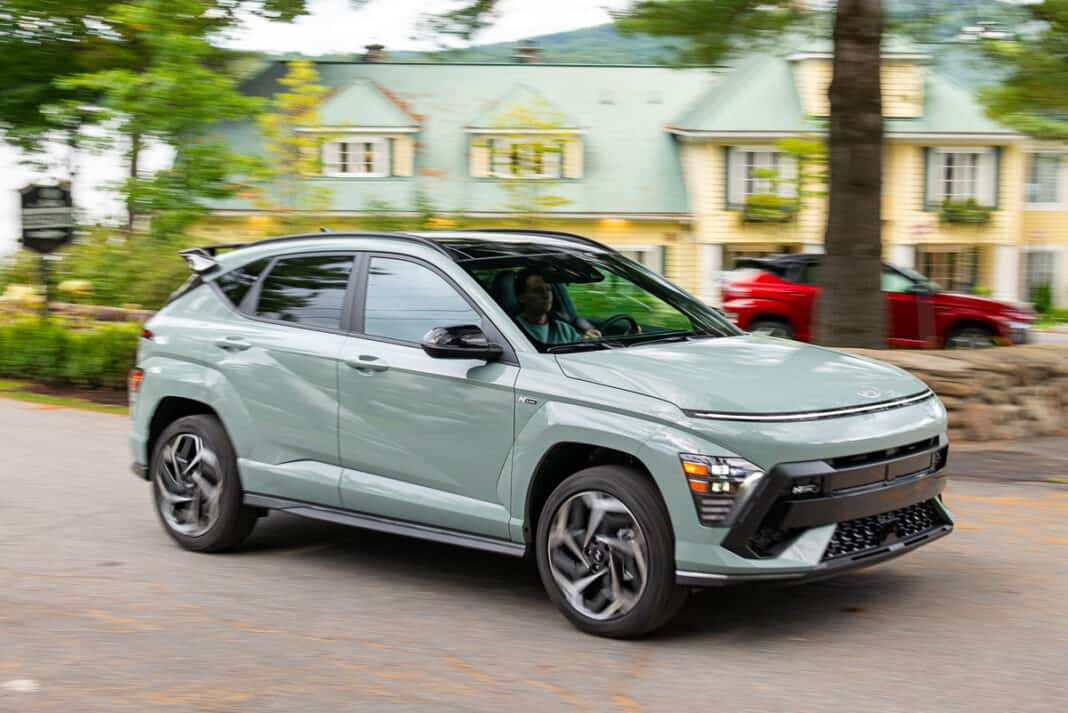 2024 Hyundai Kona N-Line front view driving with red Kona in the background