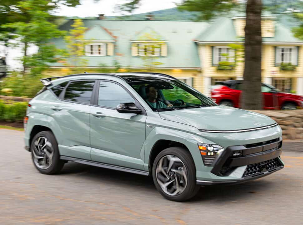 2024 Hyundai Kona N-Line front view driving with red Kona in the background