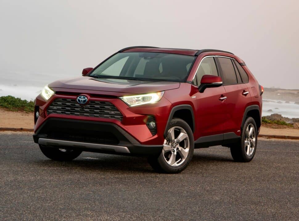 2019 Toyota RAV4 Limited Hybrid in red parked by ocean