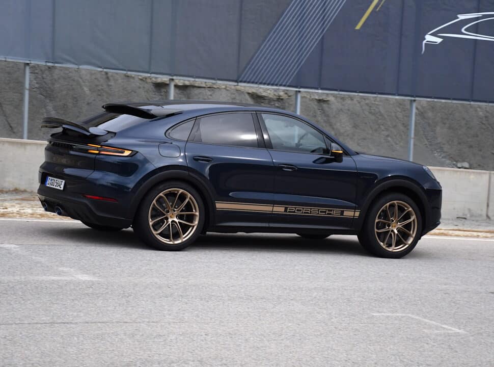 2024 Porsche Cayenne Turbo E Hybrid in blue rear view parked on the street