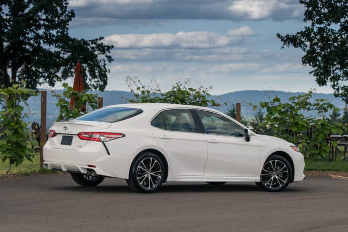 2018 Toyota Camry Hybrid SE rear shot parked by trees at vineyard