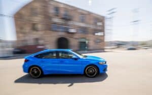 2022 Honda Civic Hatchback Sport Touring side view driving fast