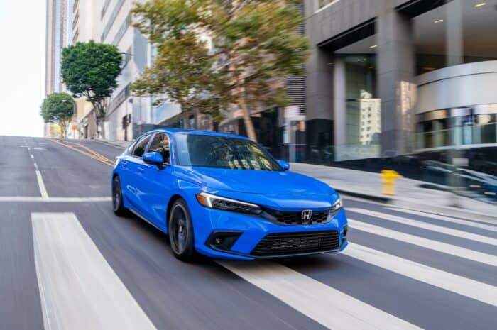 2022 Honda Civic Hatchback Sport Touring front view driving fast on the road