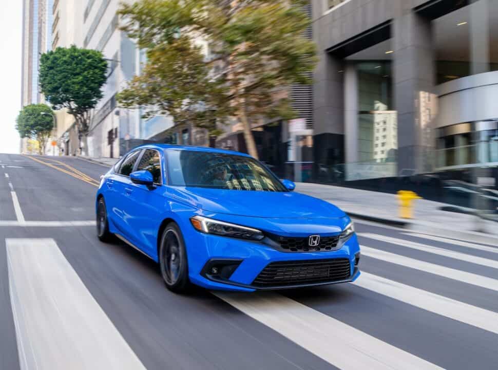 2022 Honda Civic Hatchback Sport Touring front view driving fast on the road