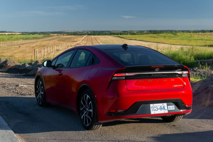 2024 Toyota Prius Prime XSE rear profile parked on road by field