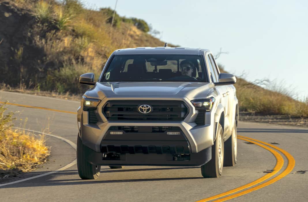 2024 Toyota Tacoma SR5 front view driving around a corner on the road