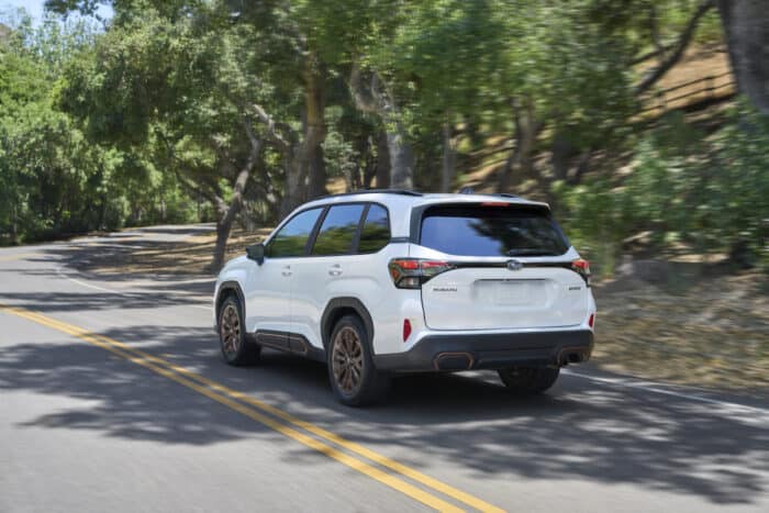 2025 Subaru Forester Sport white rear driving fast