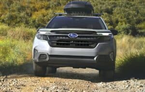 2025 Subaru Forester with roof rack driving up hill