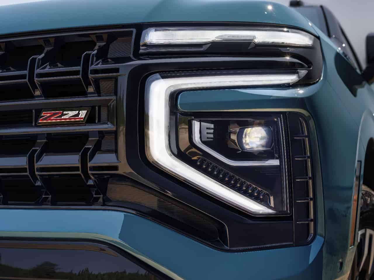 Detailed shot of new headlight and Z71 badge in grille of the 2025 Tahoe