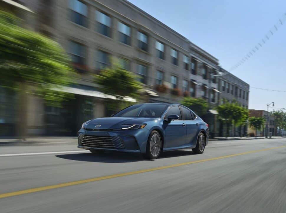 2025_Toyota-Camry_XSE in blue driving fast on road front view