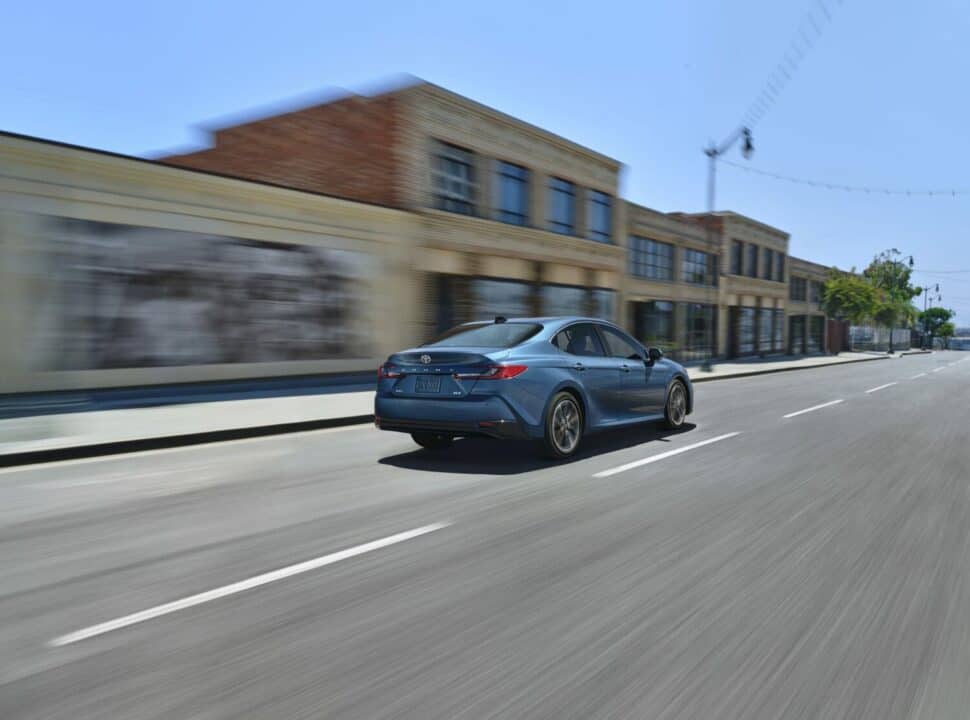 2025_Toyota-Camry_XSE in blue driving fast on road rear view