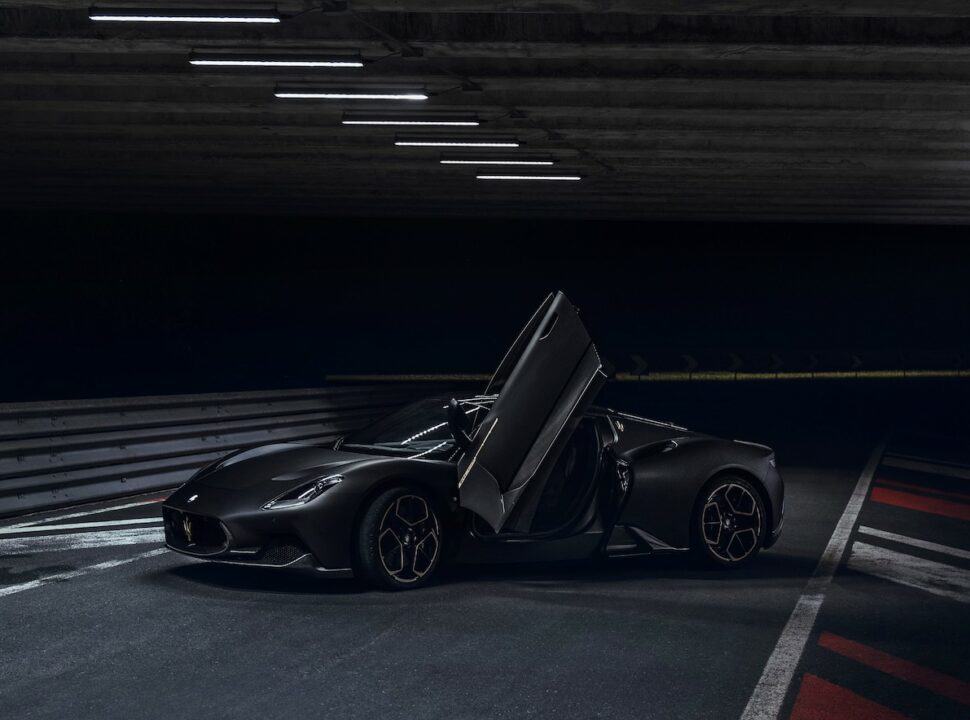 Maserati MC20 Notte Edition parked on racetrack with doors open at night front view