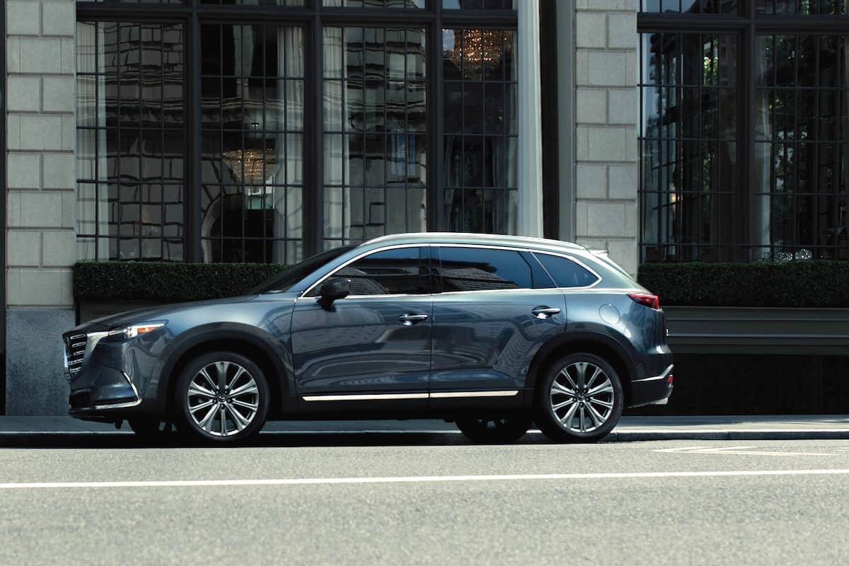 sideview of 2023 Mazda CX-9 parked on city street