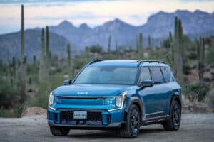 2024 Kia EV9 GT-Line front view parked at sunset with mountains and cactus in background