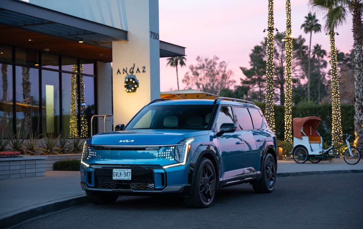 blue 2024 Kia EV9 GT-Line in front of hotel lobby