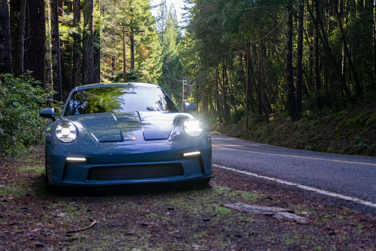 2024 Porsche 911 S/T front grill view parked in forest roadside