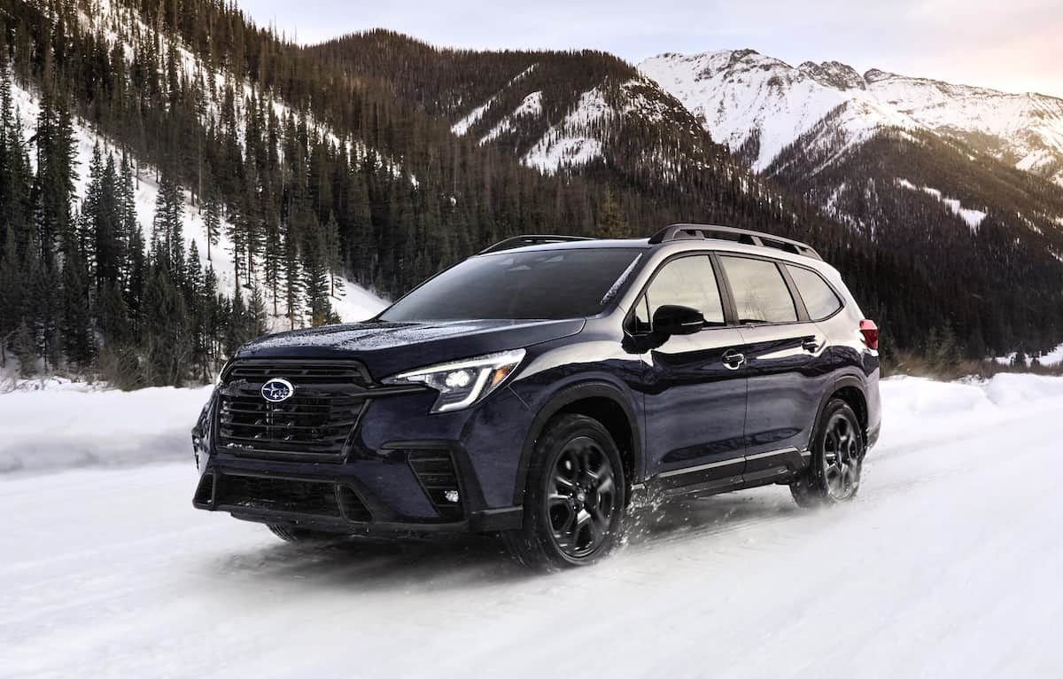 dark 2024 Subaru Ascent driving in the snow