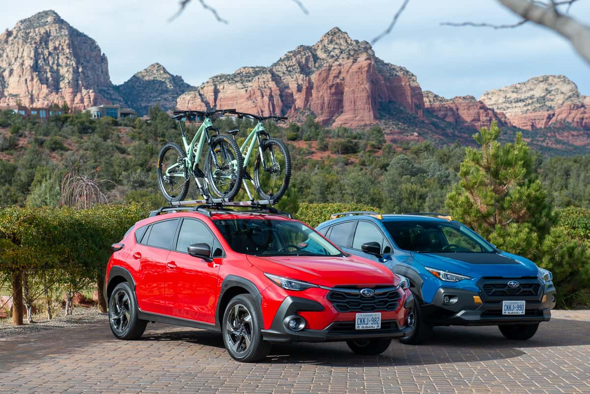 2024 Subaru Crosstrek Wilderness in blue and Crosstrek Limited in red parked next to each other