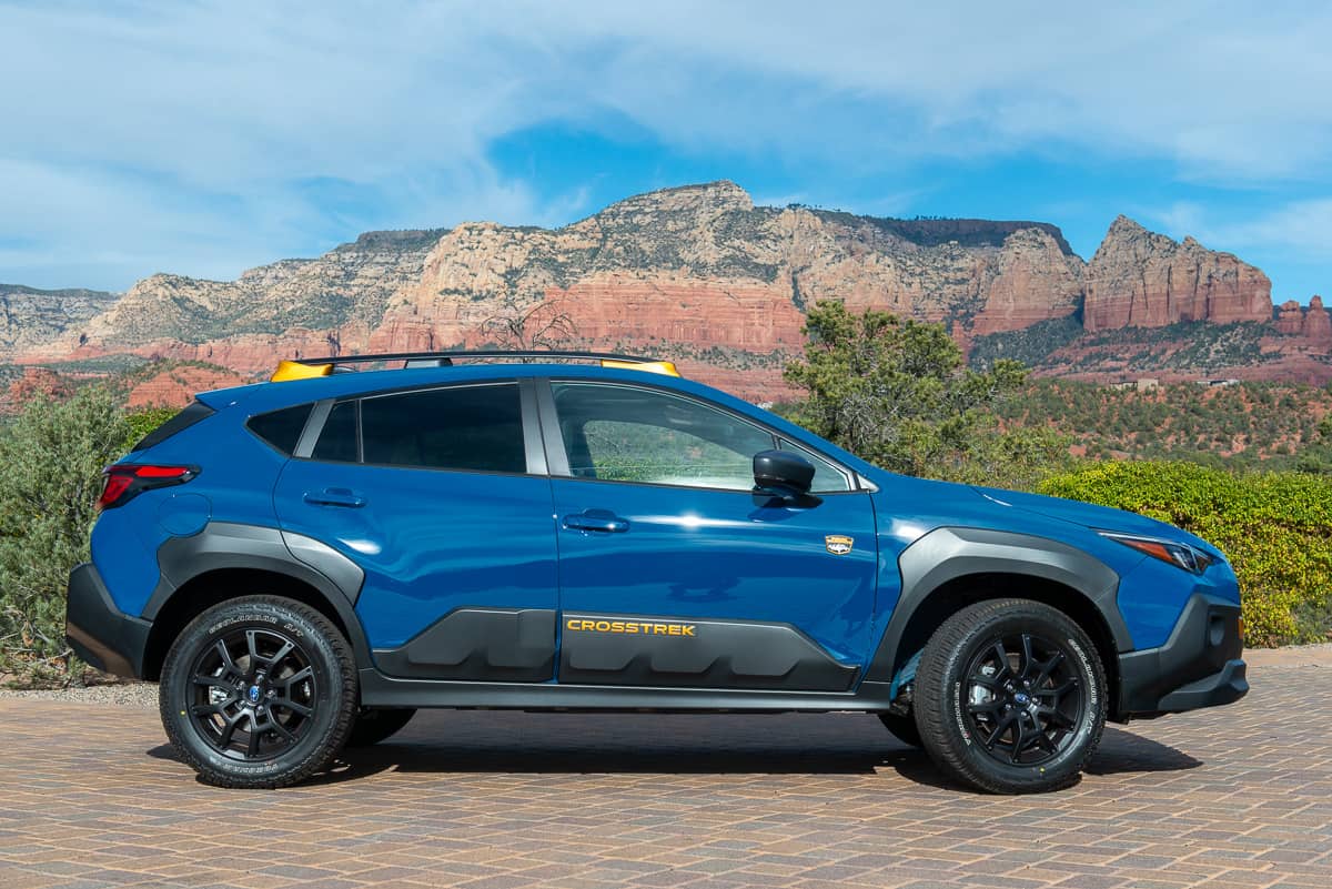 2024 Subaru Crosstrek Wilderness in blue sideview parked on driveway in Sedona