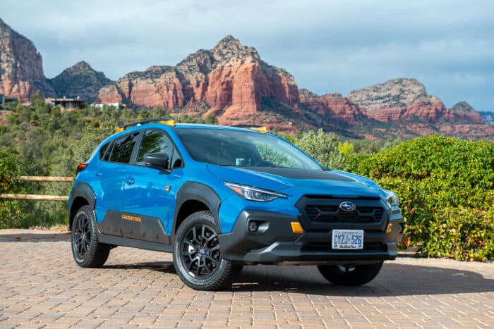 2024 Subaru Crosstrek Wilderness in blue front profile in Sedona with mountains in the back