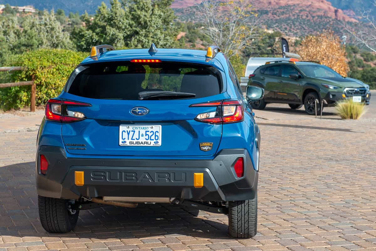 2024 Subaru Crosstrek Wilderness rear shot next to green model front