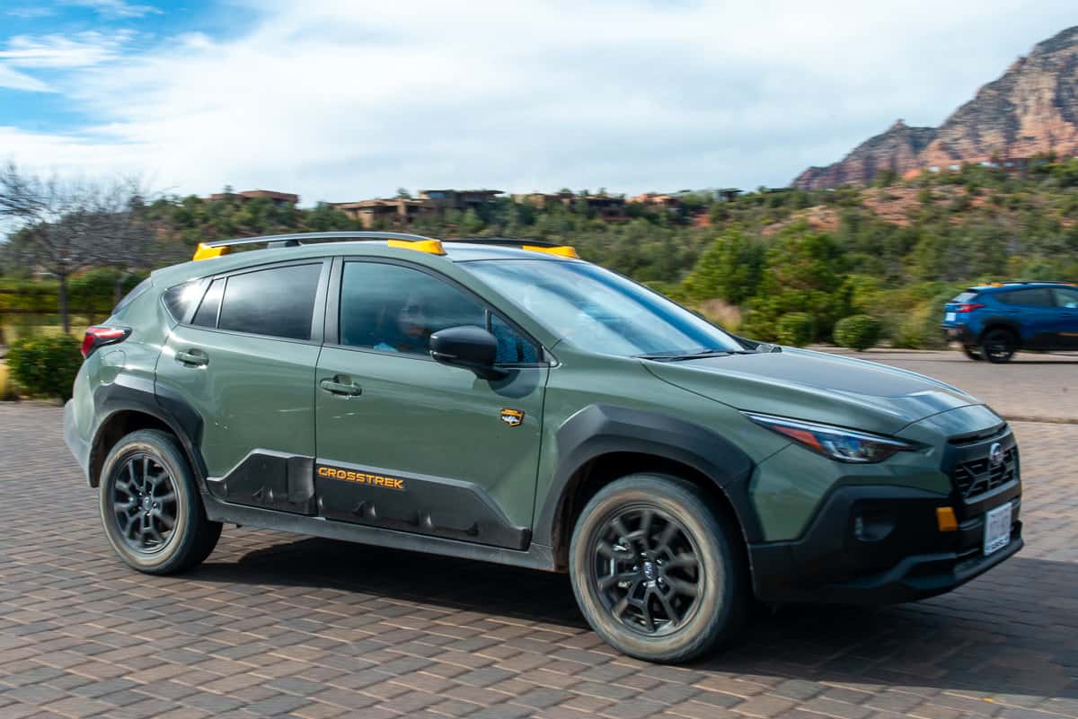 2024 Subaru Crosstrek Wilderness driving down a driveway