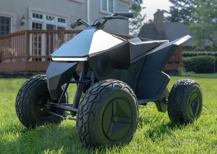 Tesla CyberQuad for Kids on the grass in a home's backyard