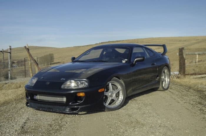 Black 1994 Toyota Supra Mk4 with bodykit and mods, front view parked