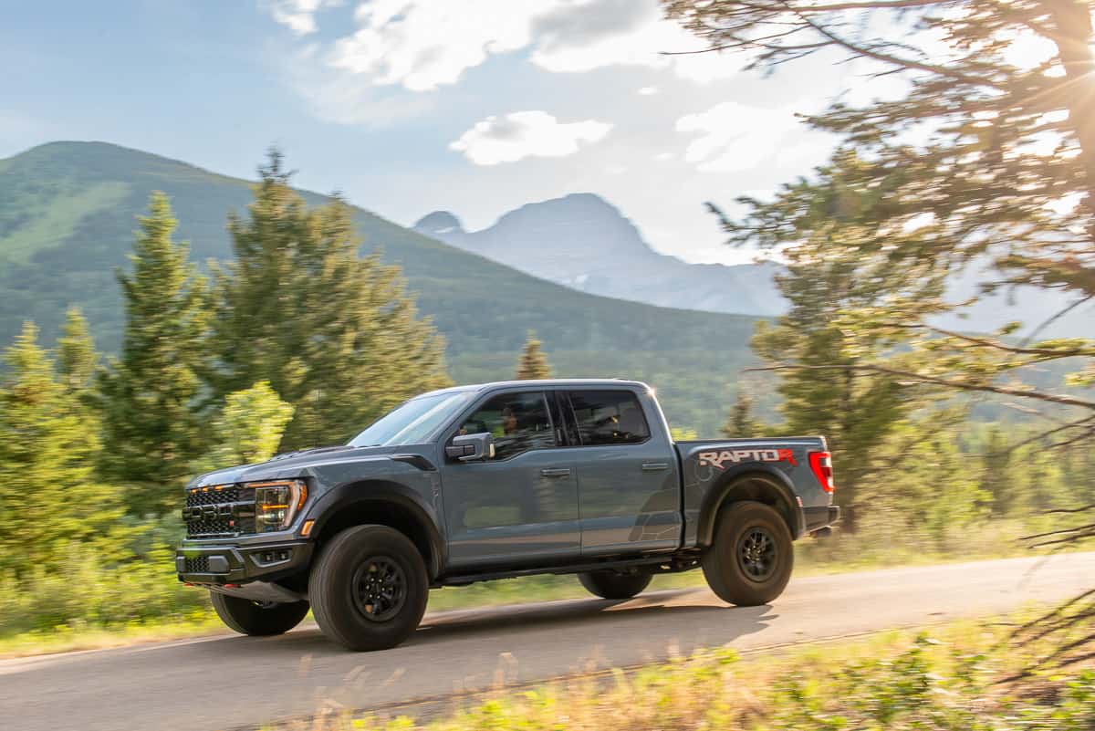 2023 Ford F-150 Raptor R driving by at sunset in the moutains