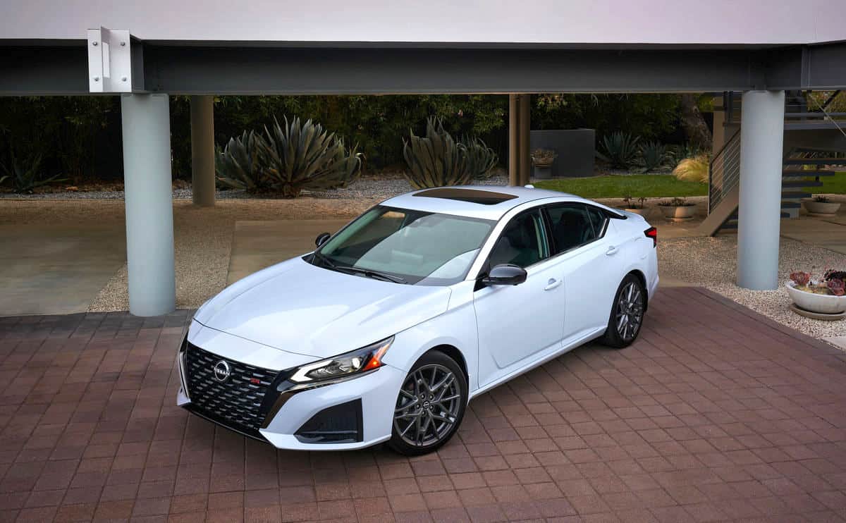 white 2024 Nissan Altima parked on garage pad