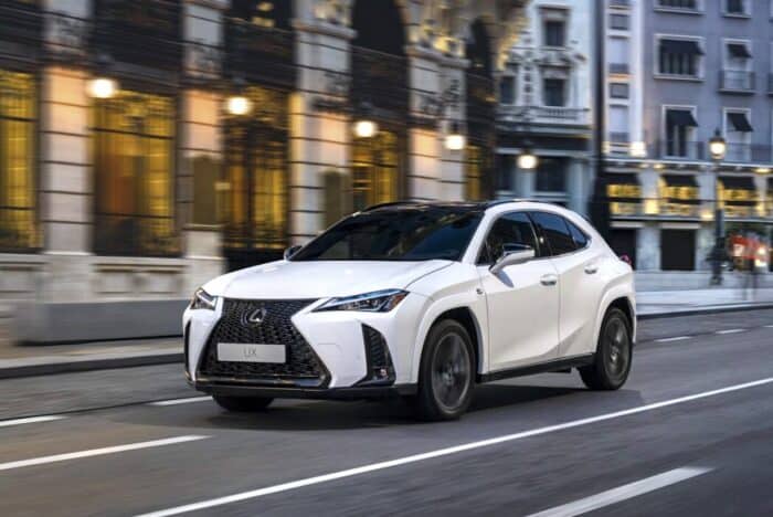 white 2025 Lexus UXh FSPORT front view driving down the street