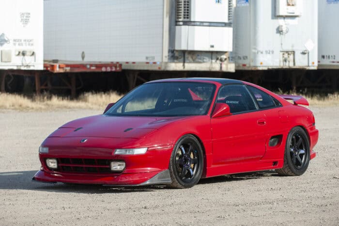red older model Toyota MR2 with bodykit front view