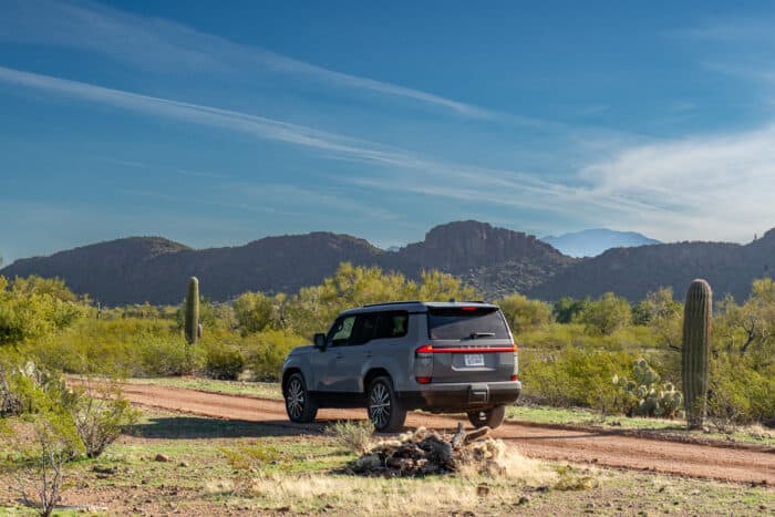 Grey 2024 Lexus GX 550 Luxury+ AWD rear view parked in desert on dirt road