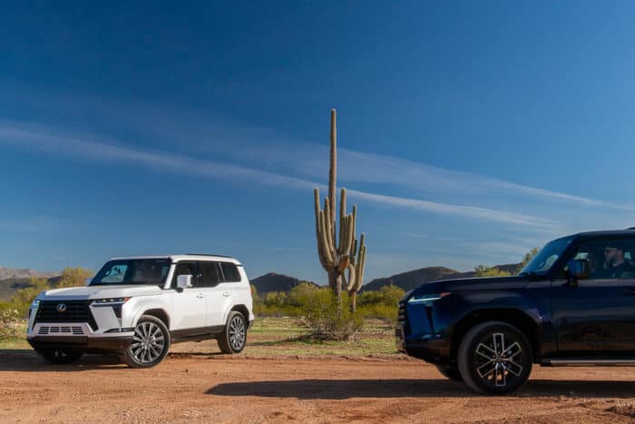 White 2024 Lexus GX 550 Luxury+ AWD and dark blue model next to each other